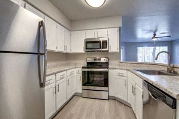 White kitchen cabinetry with stainless steel appliances